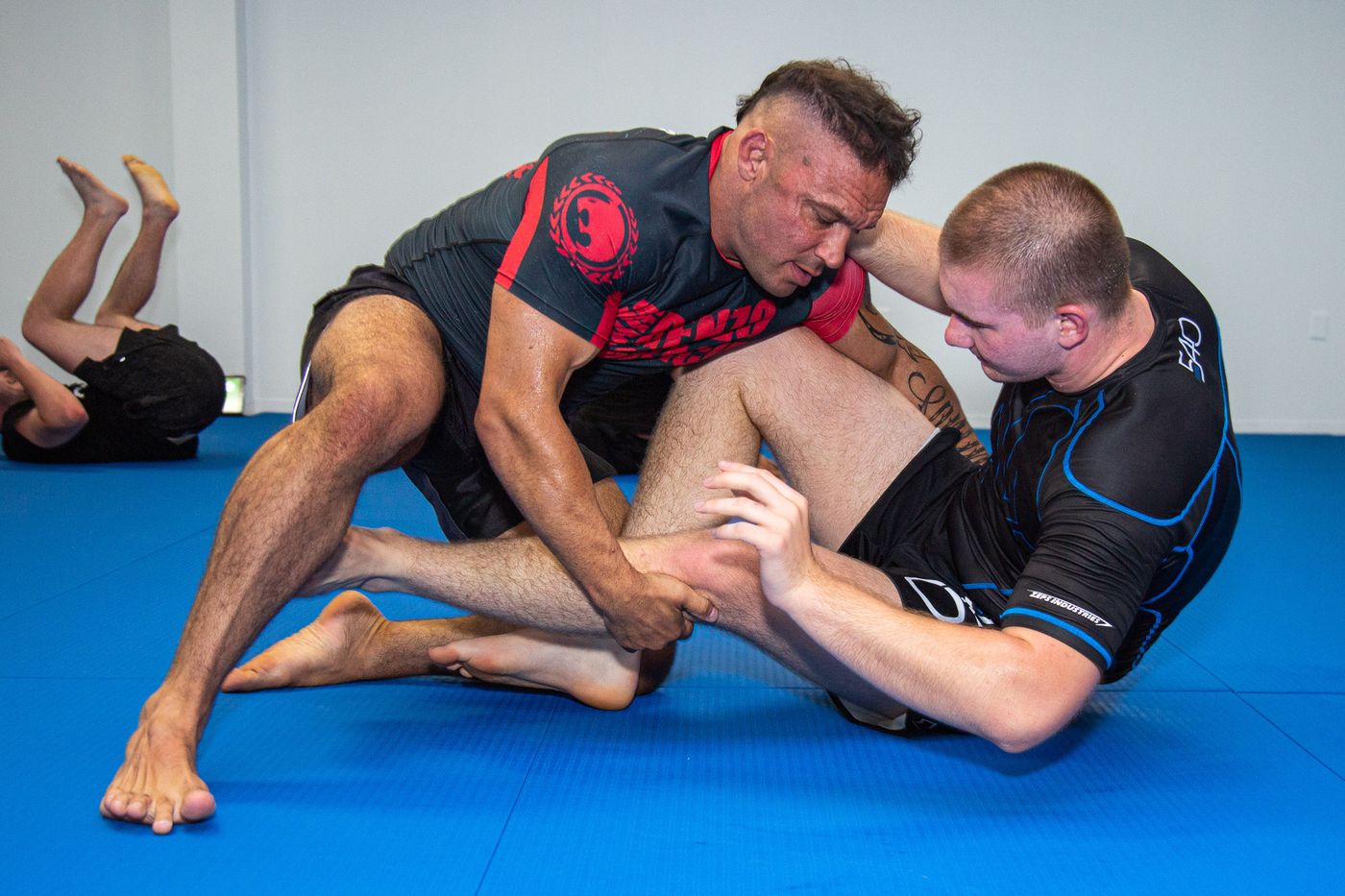 Two athletes battling for leg position in a No-Gi grappling class at Renzo Gracie Milford