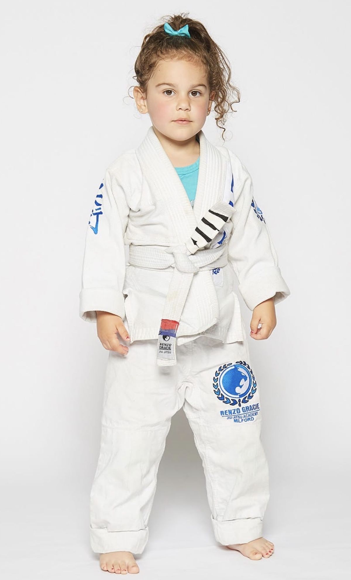 A Future Leaders student, about four years old, standing in her white gi and white belt at Renzo Gracie Milford